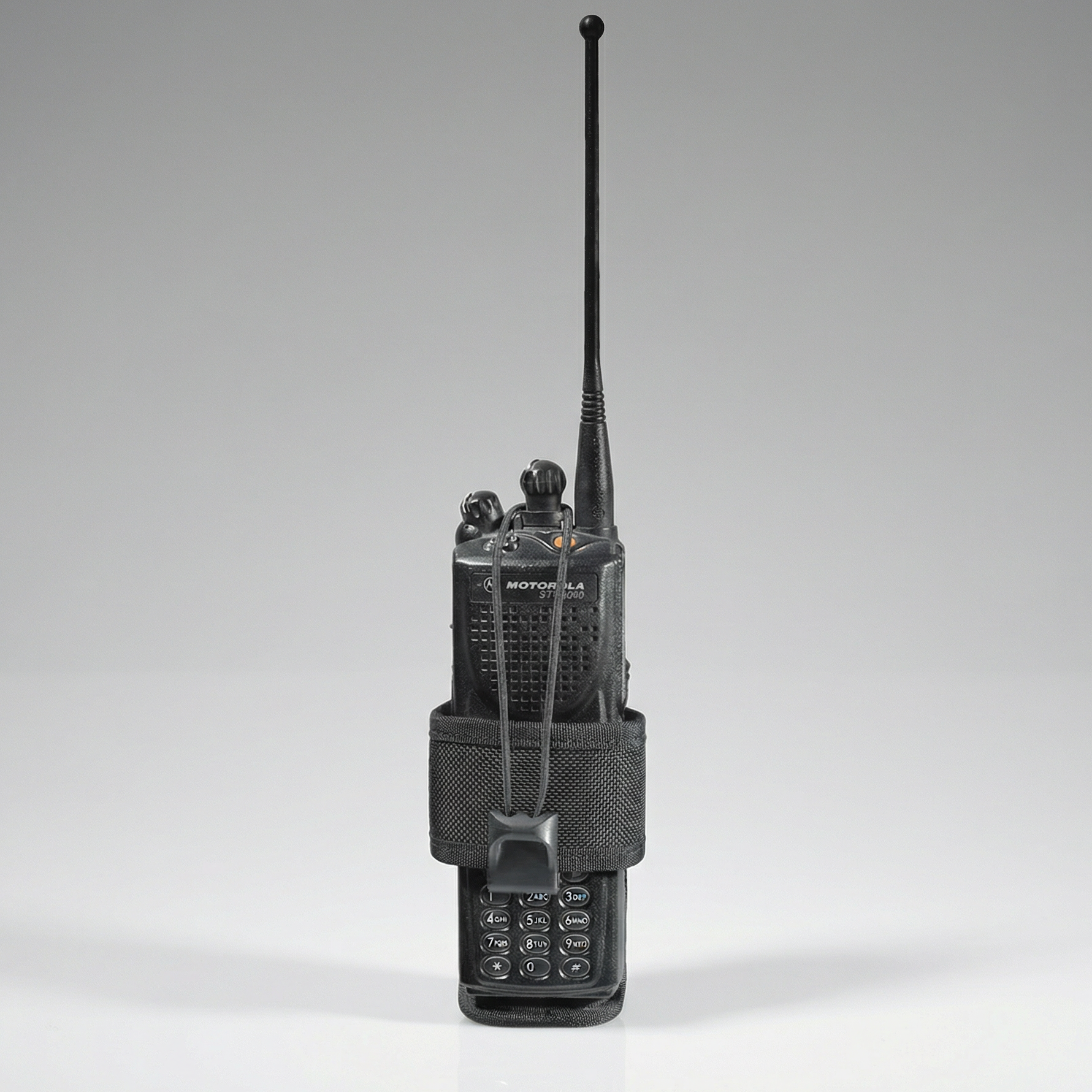 Black walkie-talkie with antenna on a gray background