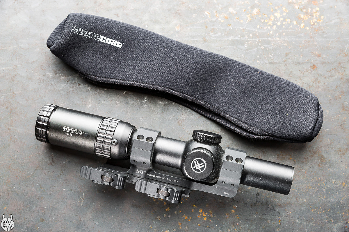 Sight on a gray surface with a black carrying case labeled 'Scope Dust'.