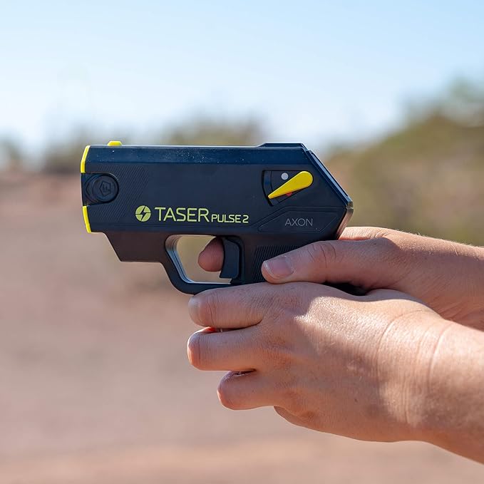 Side view of a person holding a Taser Pulse 2