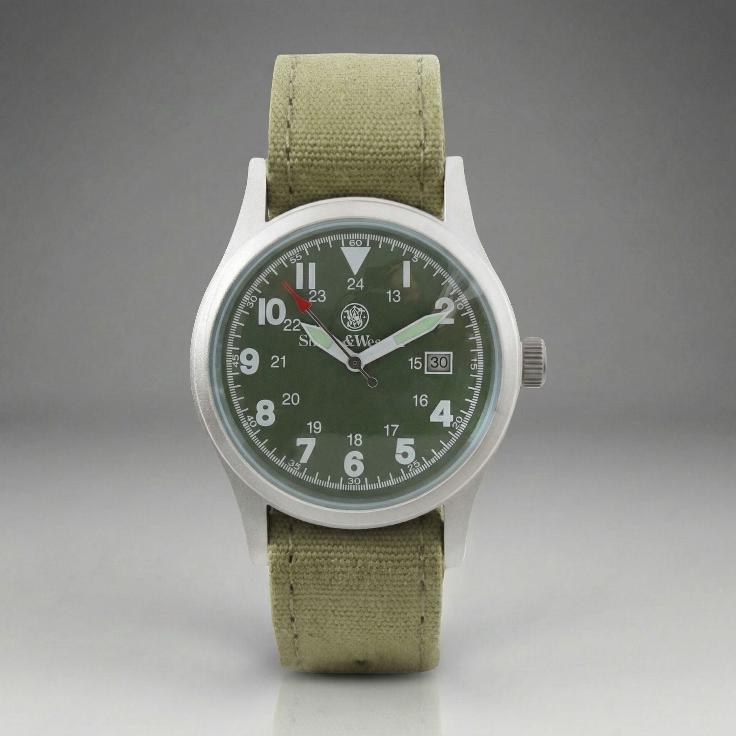 Watch with green strap and dark green dial on a gray background