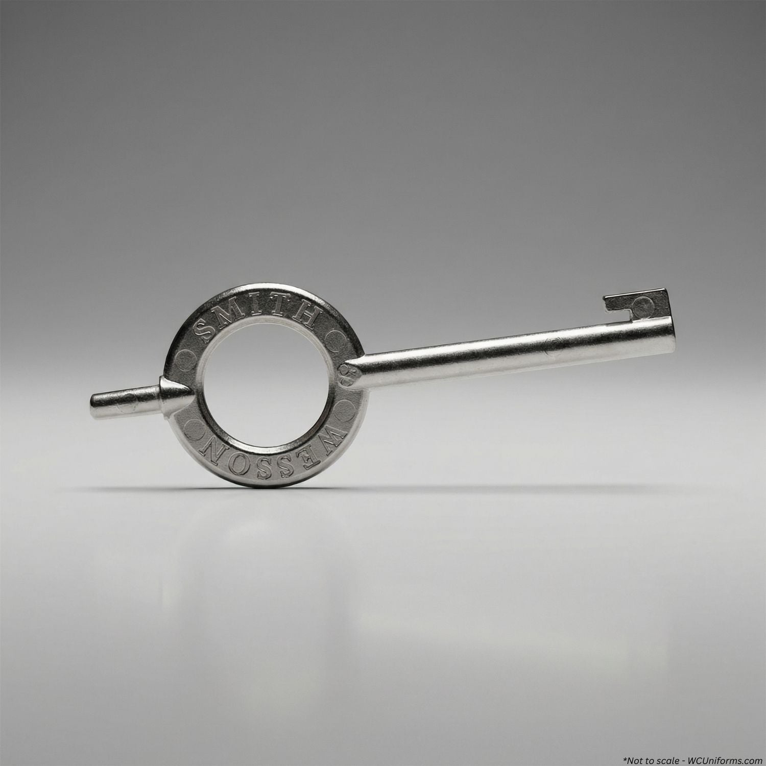 Metal key with 'Smith & Wesson' engraving on a gray background
