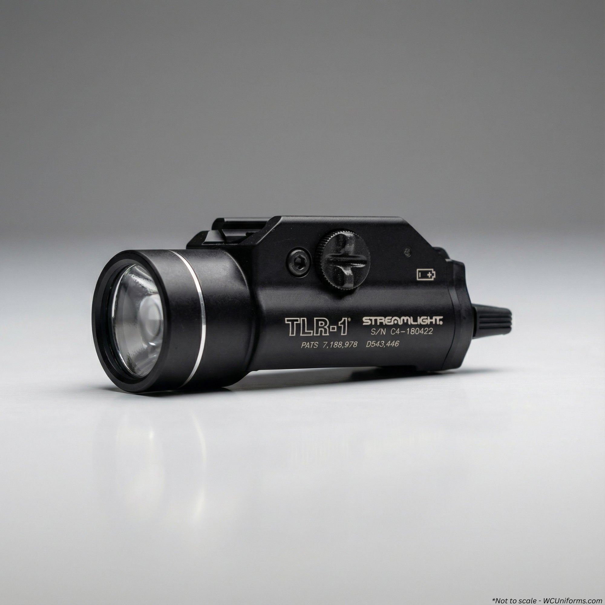 Black tactical flashlight with 'Streamlight' branding on a gray background