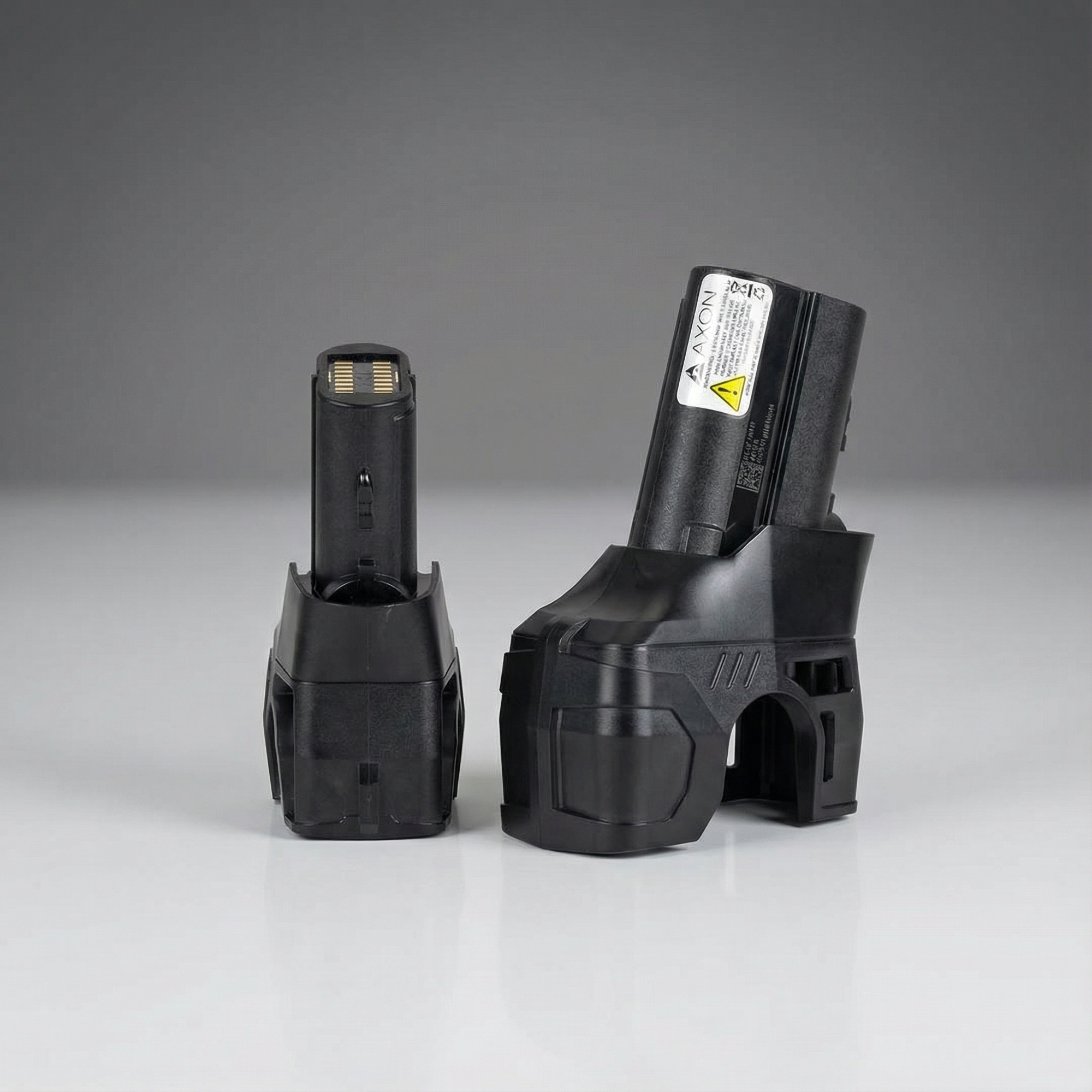 Two black battery packs on a gray background