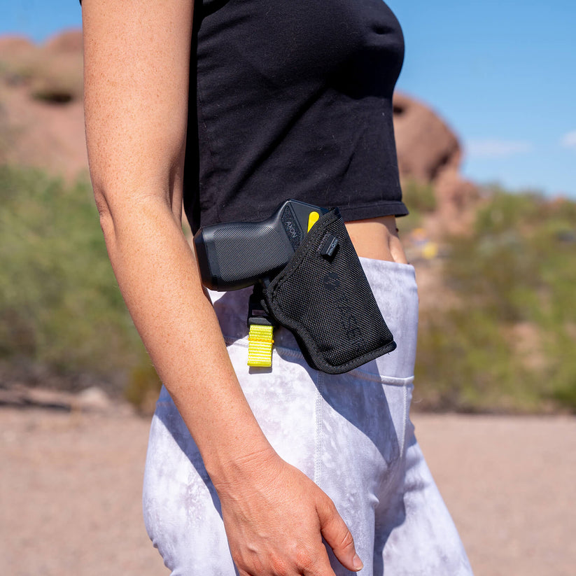 Image showing a woman wearing a Taser Pulse 2 in a holster on her hip