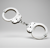 Metallic handcuffs on a gray background