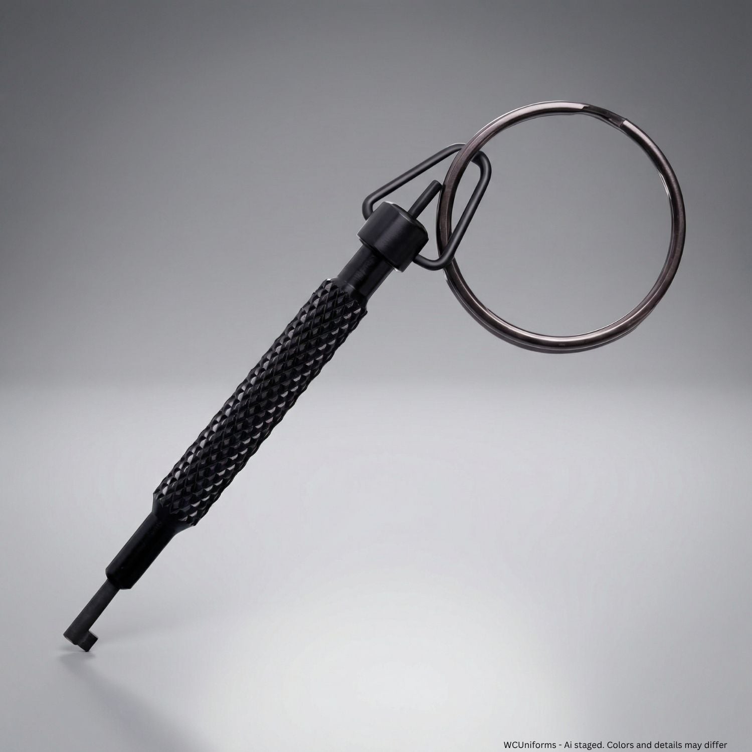 Black handcuff key with a ring on a gray background