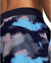 Close-up of a person wearing a black and blue patterned swimsuit.