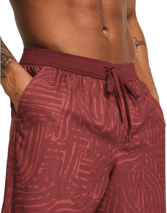 Maroon patterned shorts worn by a person on a white background