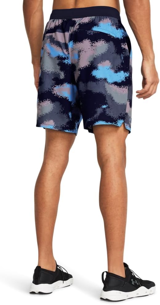 Person wearing colorful camouflage shorts on a plain background
