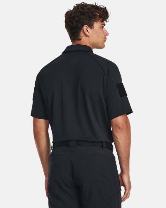 Back view of a man wearing the Under Armour Men's UA Tac Elite Polo, showcasing its tactical design and comfortable fit.