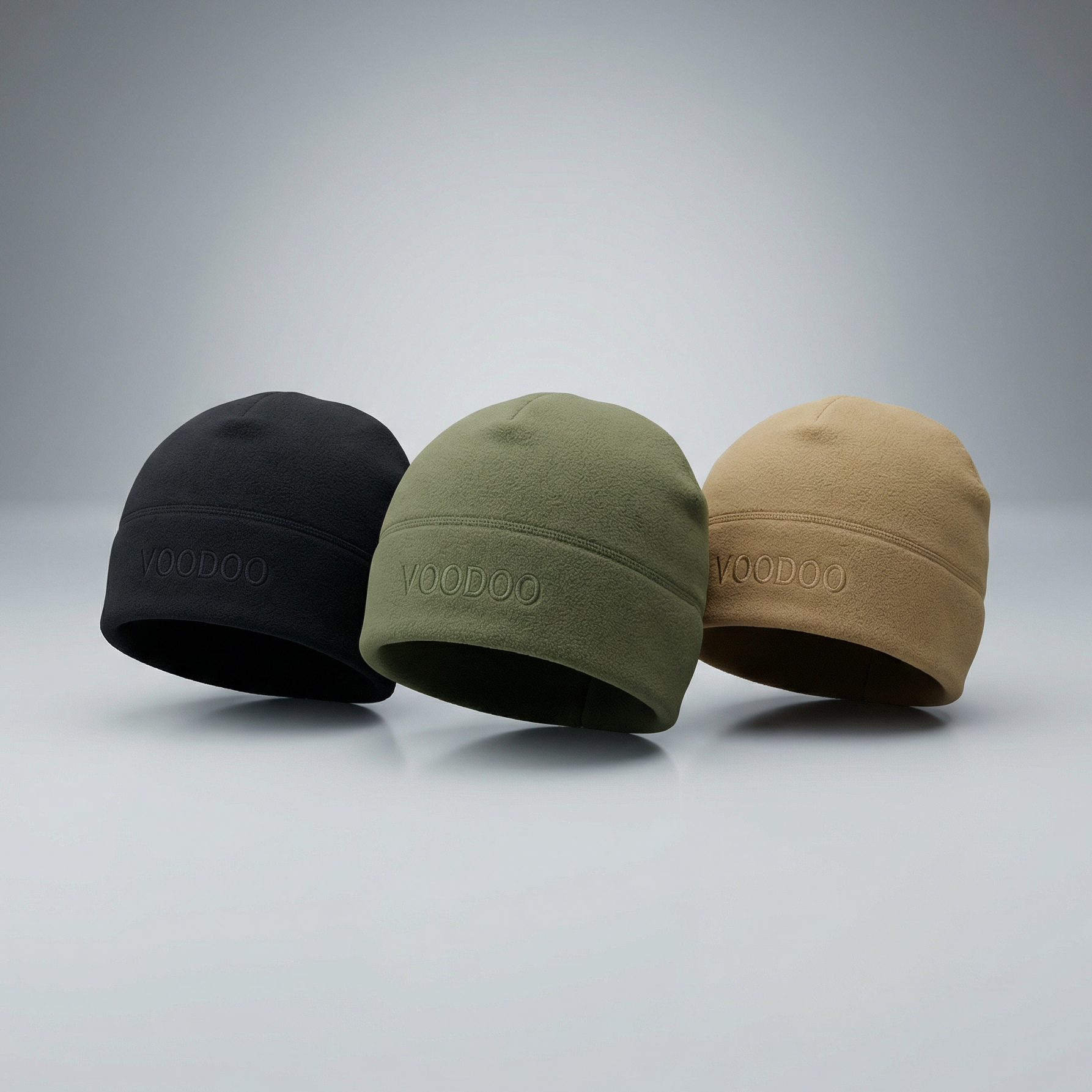 Three beanies in black, green, and beige on a gray background