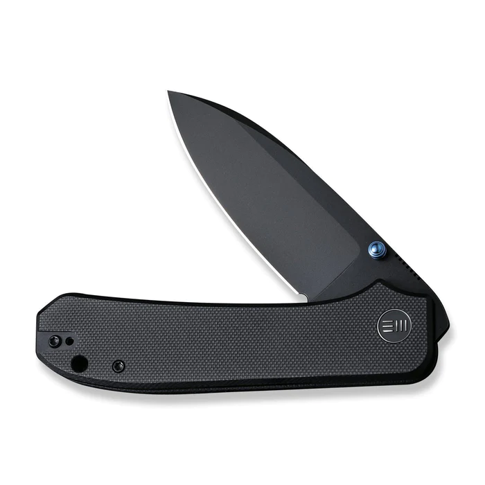 We Knife Big Banter Thumb Stud Knife with sleek black handle and sharp blade, designed for quality and innovation.