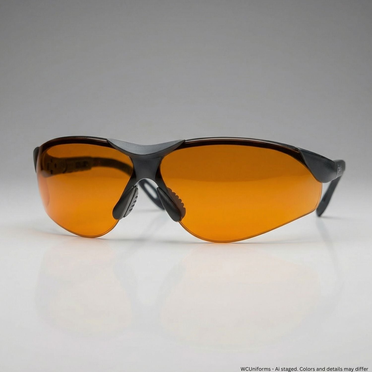 Sunglasses with orange lenses and black frames on a gray background