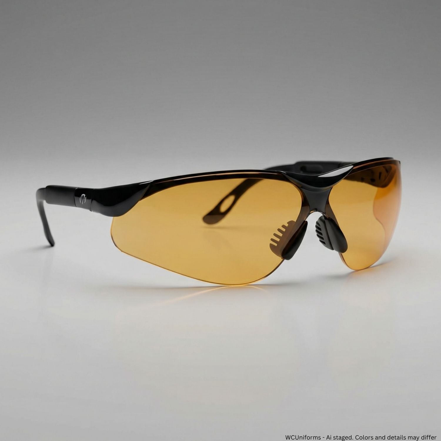Sunglasses with black frames and amber lenses on a gray background