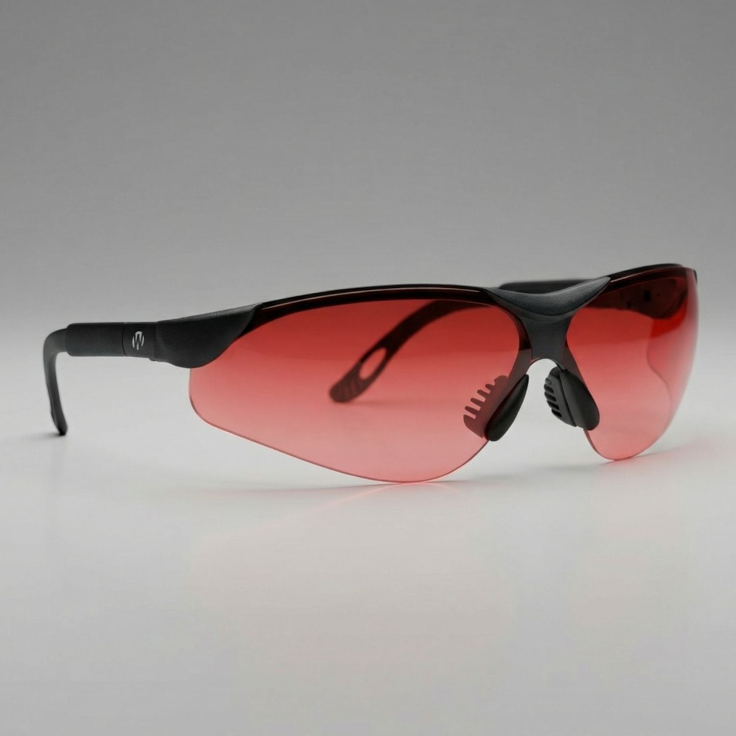 Sunglasses with red lenses and black frame on a gray background