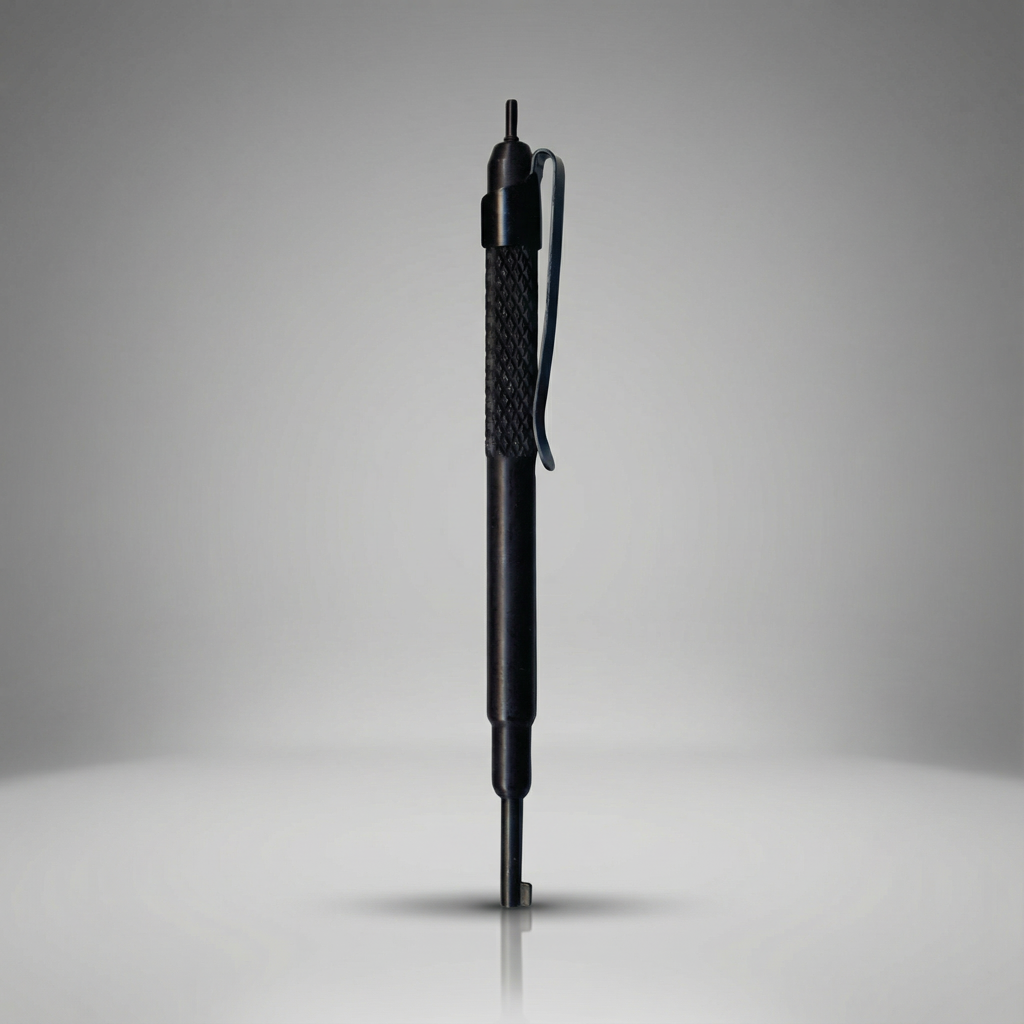 Black handcuff key with textured grip on a gray background