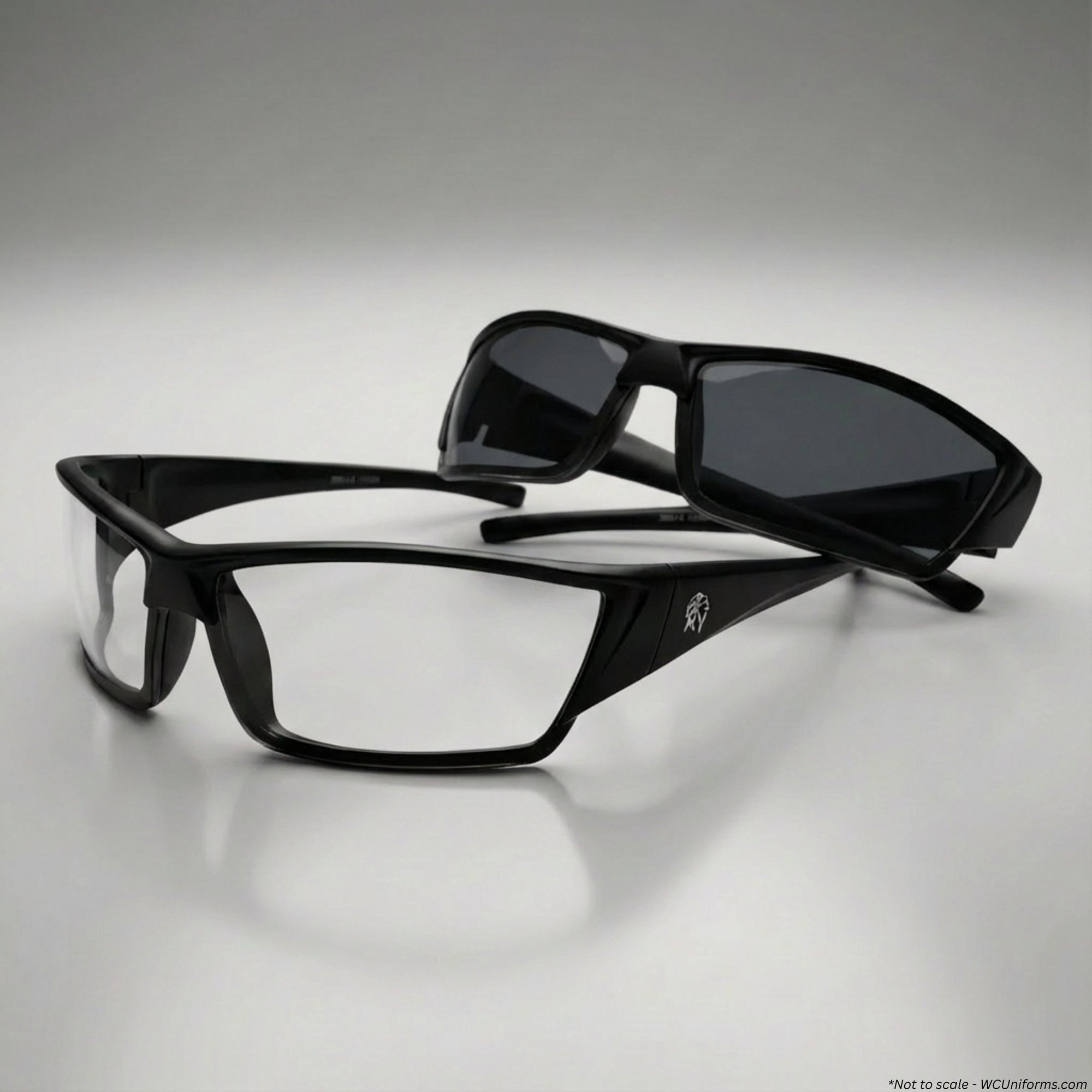 Black eyeglasses and sunglasses on a gray background