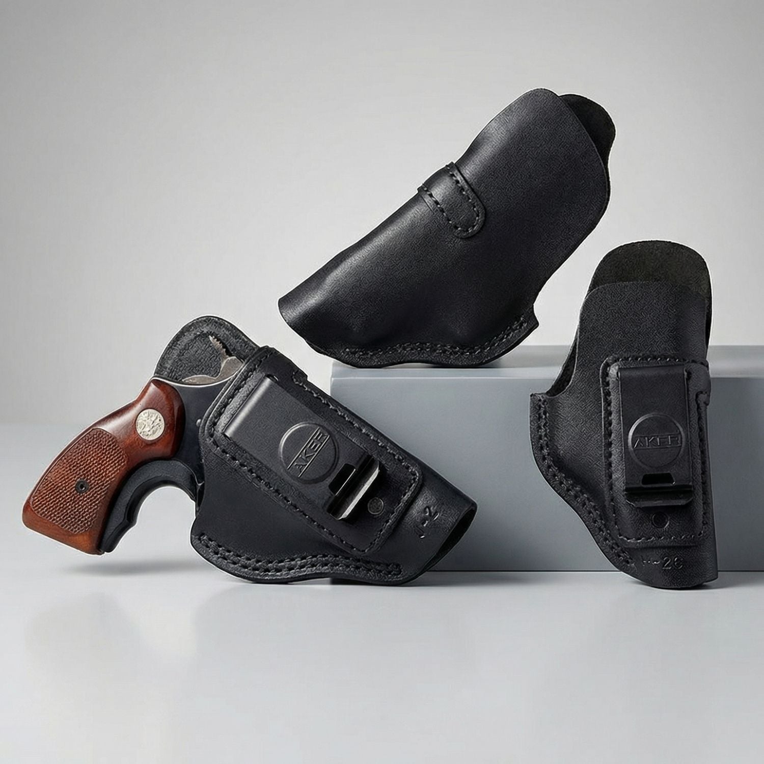 Black gun holsters with a gun on a gray background