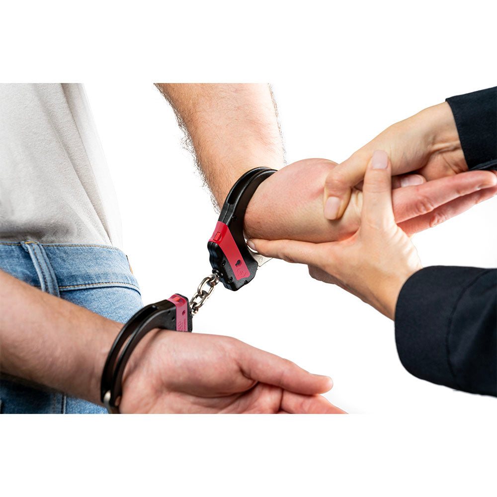 ASP 07440 red training handcuffs applied to a wrist, showing keyless chain link design