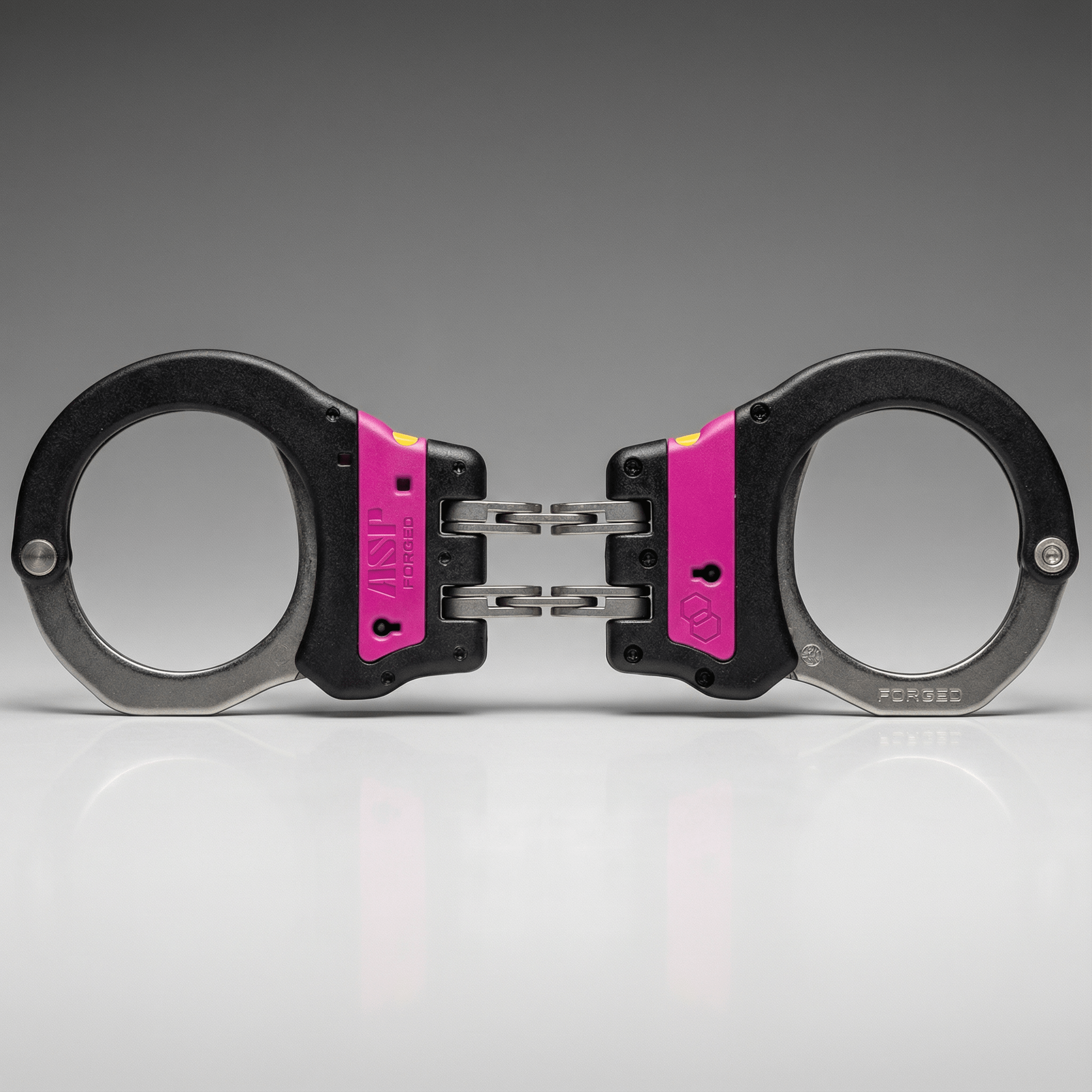 Handcuffs with pink accents on a gray background