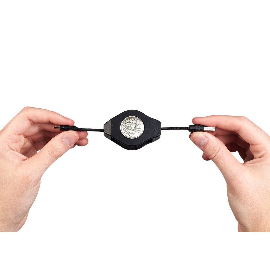 Two hands holding a black electronic device with a brand logo on a white background