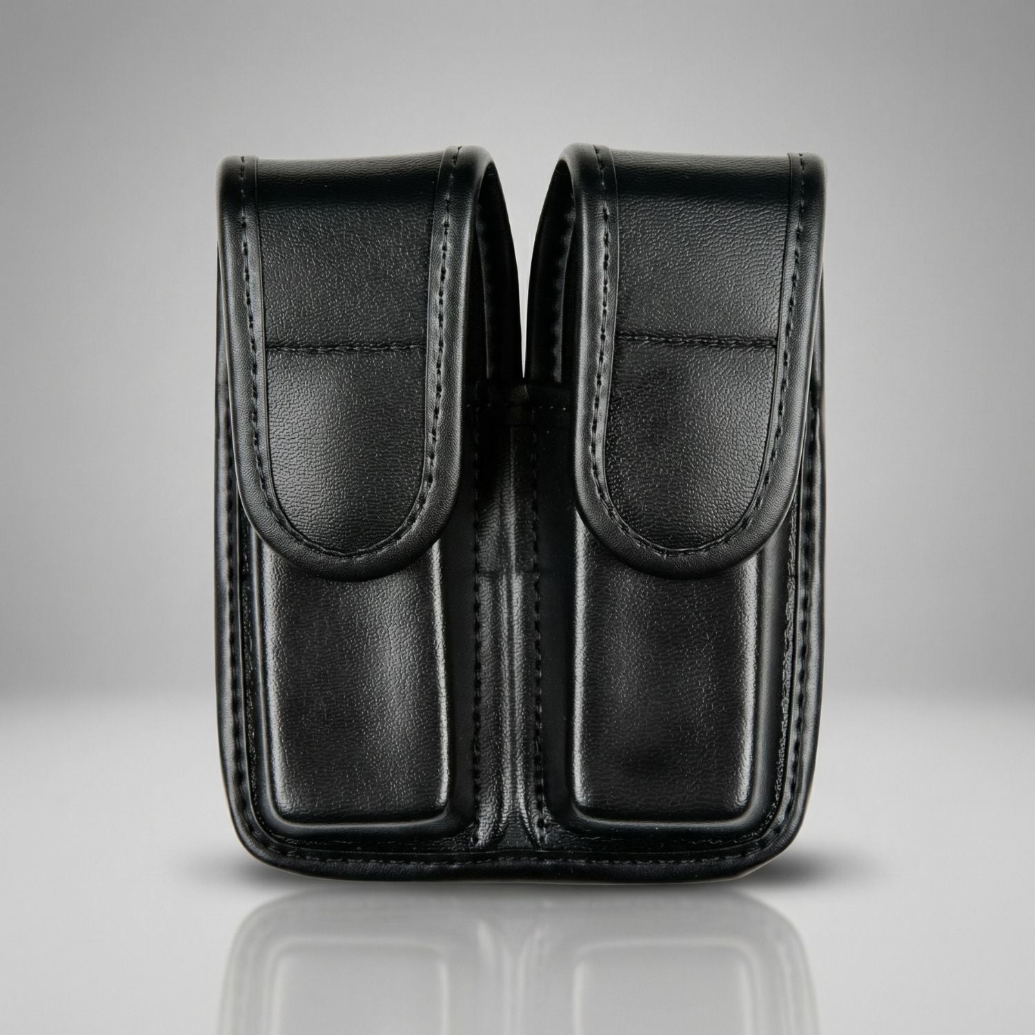 Black leather double magazine pouch on a gray background