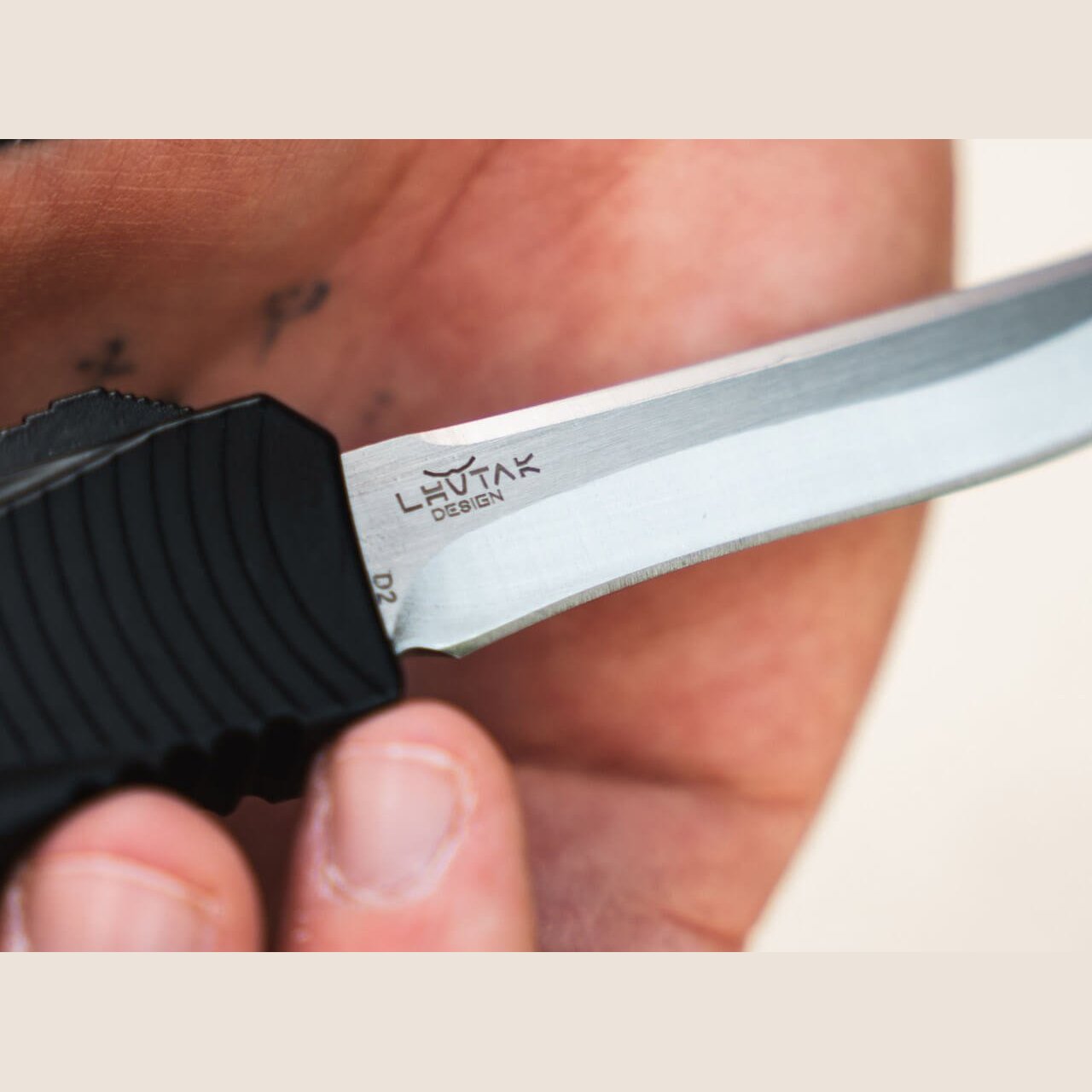 Satin two-tone D2 recurve blade with Lhotak Design mark on the Böker Plus Eagle 2.0 OTF