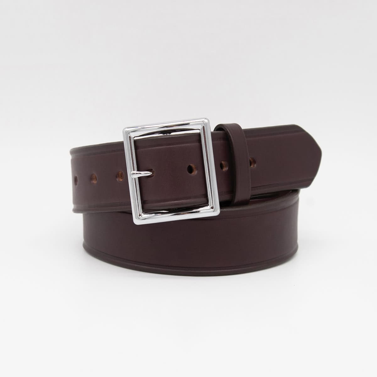 A dark brown leather belt with a polished silver-tone metal buckle, neatly coiled on a light gray background.