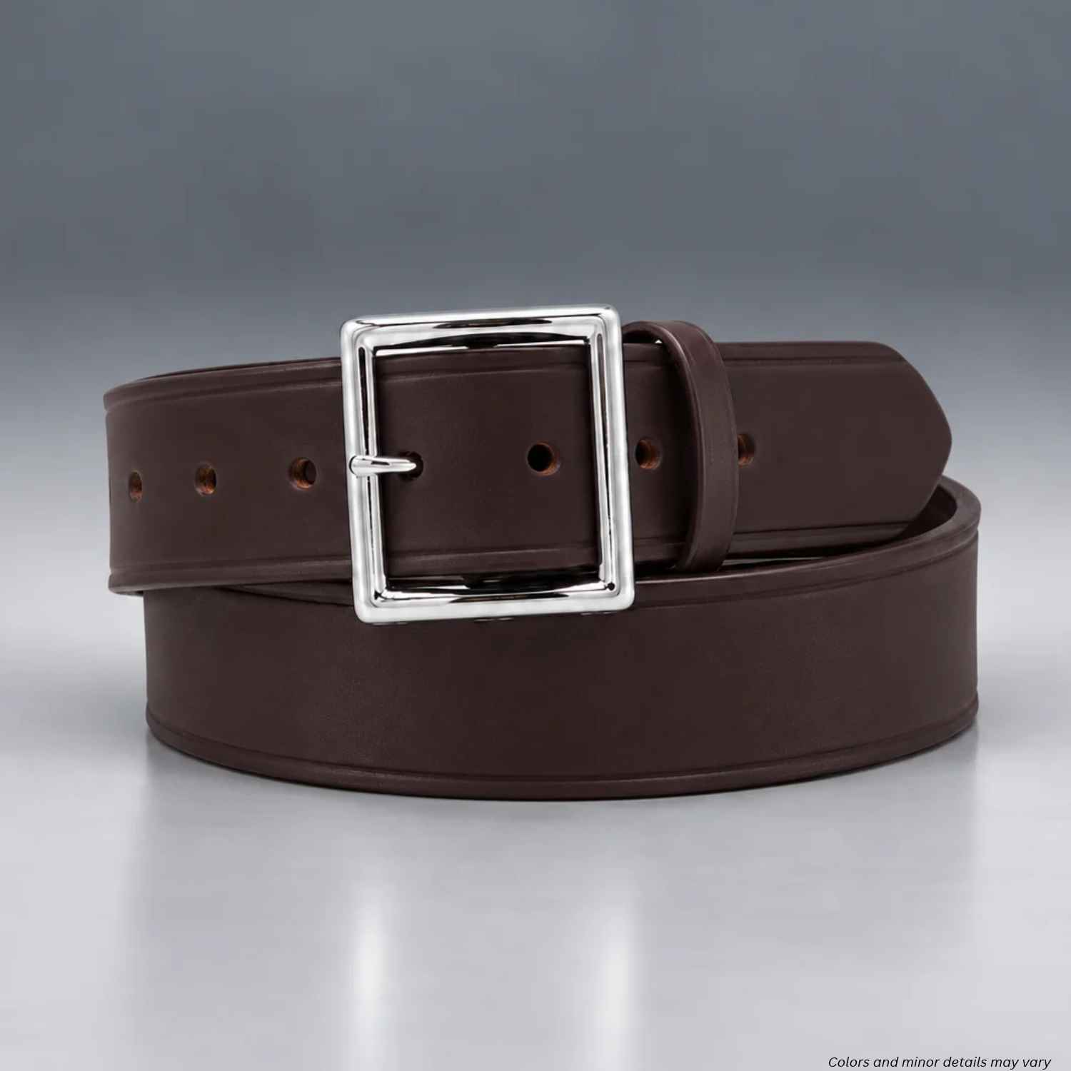 A dark brown leather belt with a polished silver-tone metal buckle, coiled and presented on a neutral gray studio background.