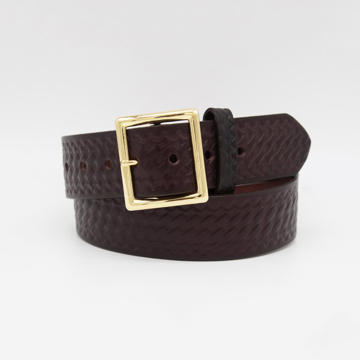 A dark brown textured leather belt with a large gold-tone buckle, coiled on a light gray background.