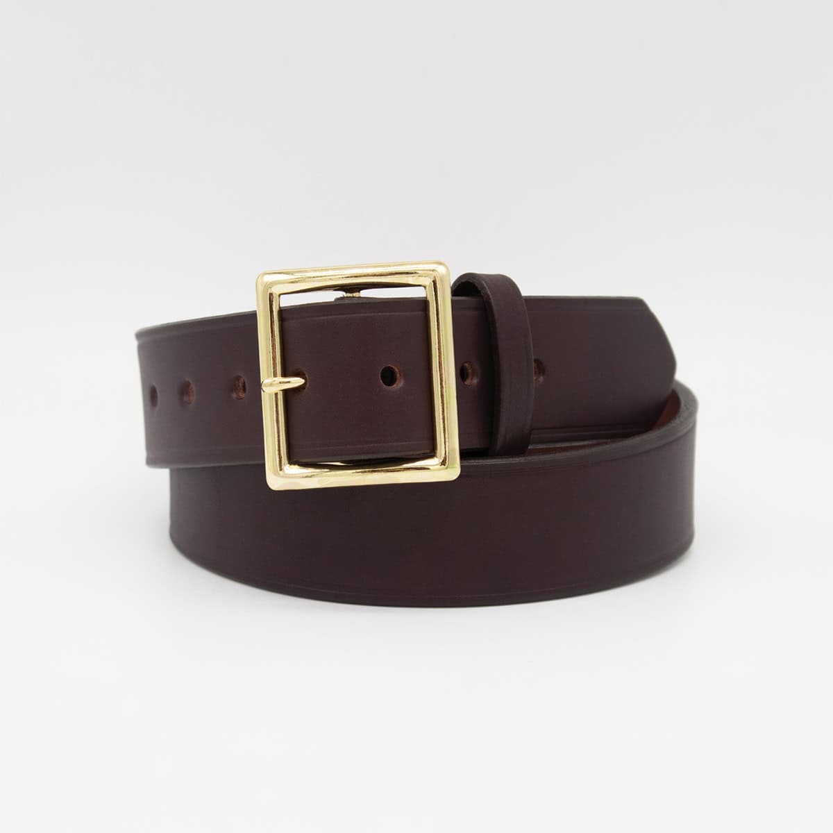 A dark brown leather belt with a polished gold-tone rectangular buckle, neatly coiled on a light gray background.