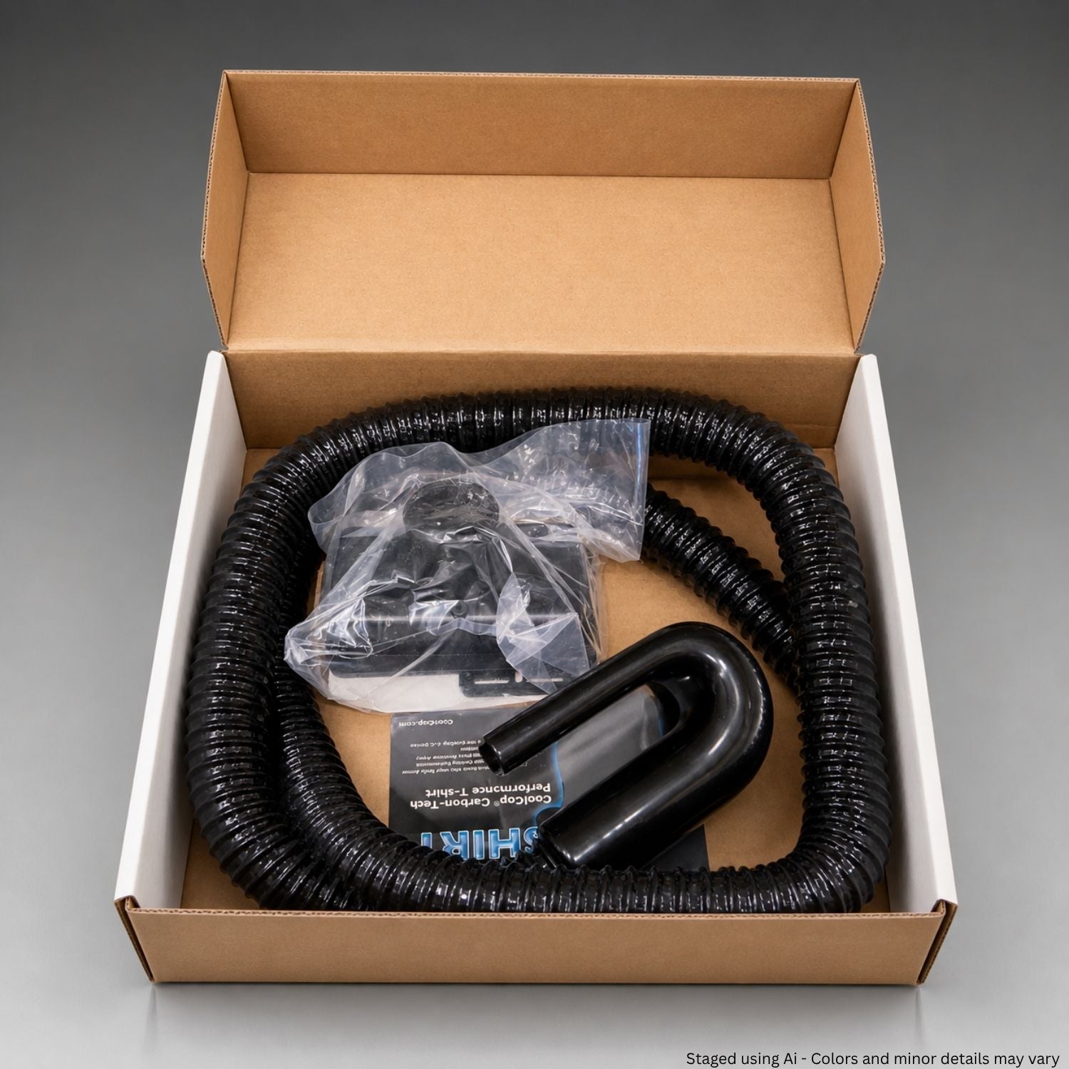 Black hose and plastic bag in a cardboard box on a gray background