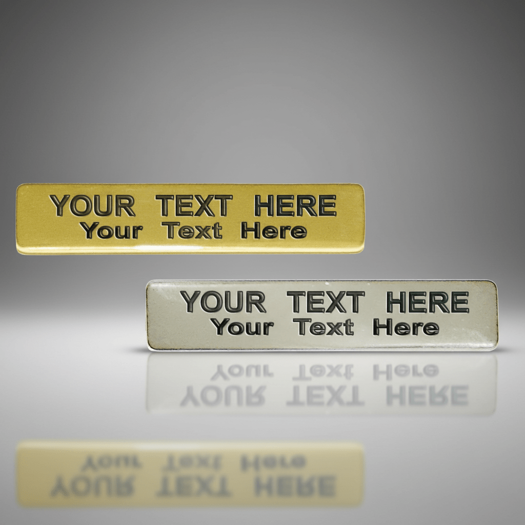 Two customizable name plates, one gold and one silver, on a gray background.