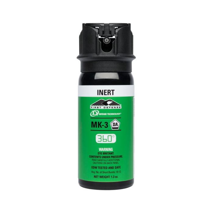 Green and black pepper spray canister labeled 'INERT' on a white background