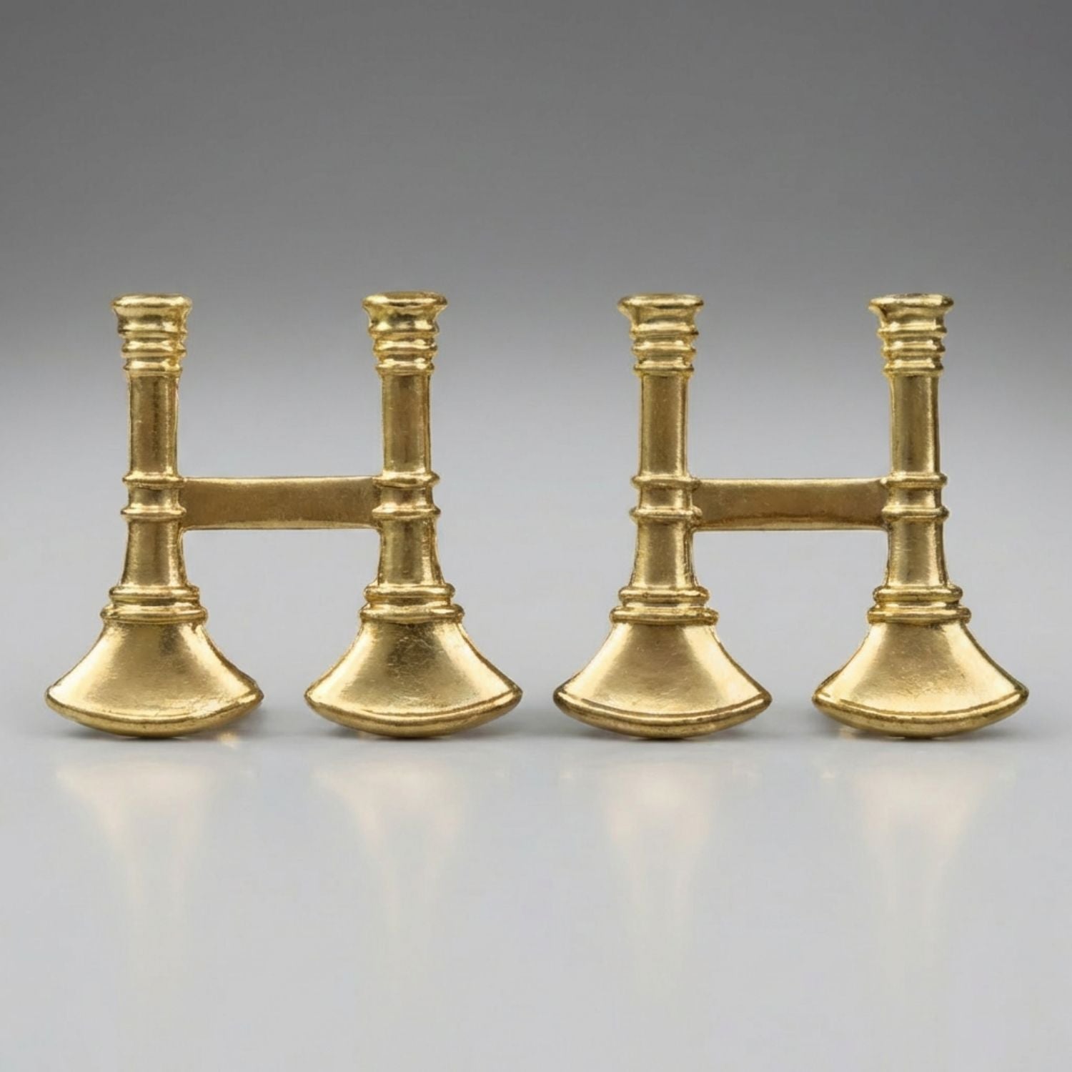 Two pairs of gold Firefighter Captain's Bugle Collar Pins on a gray background
