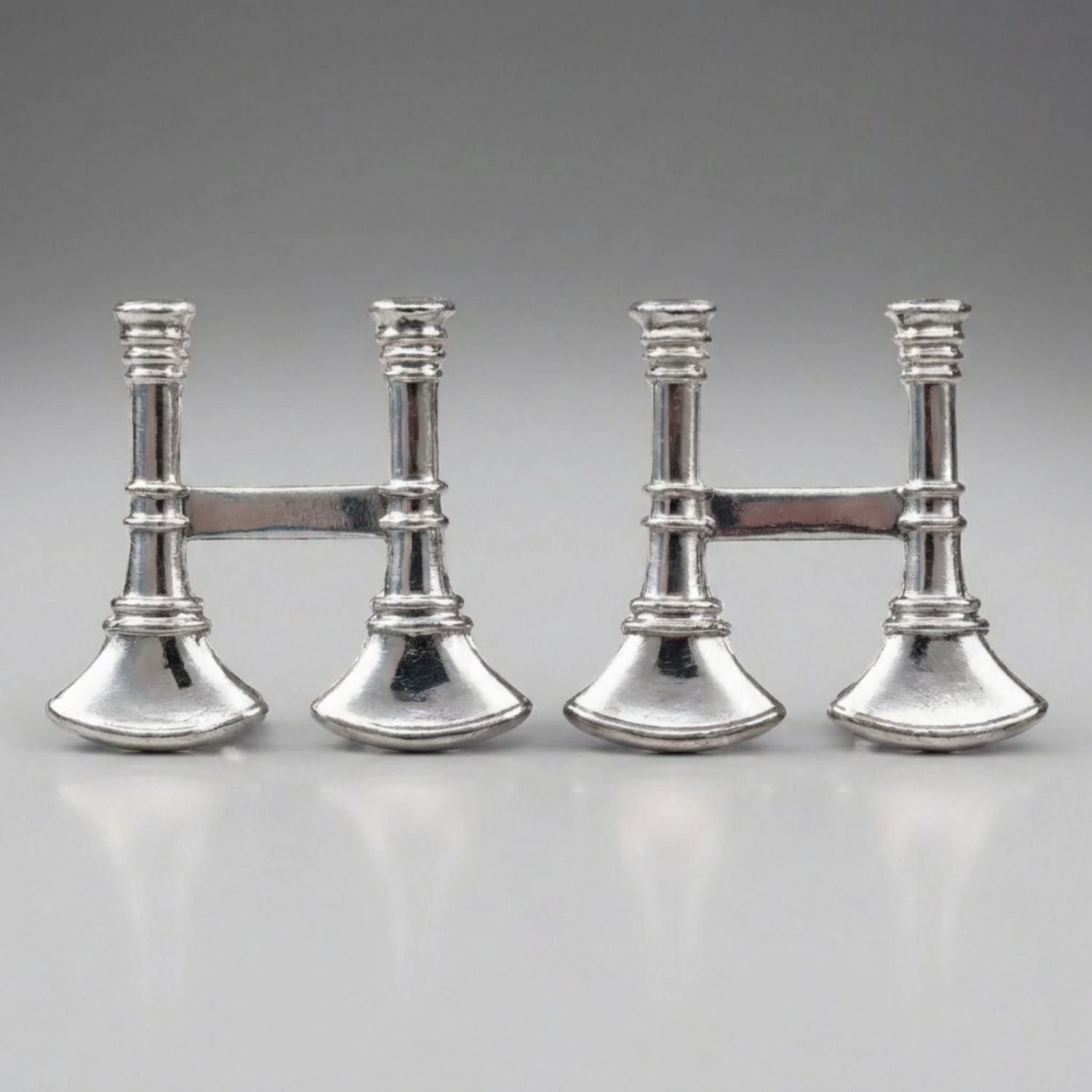 Four silver Firefighter Captain's Bugle Collar Pins on a gray background