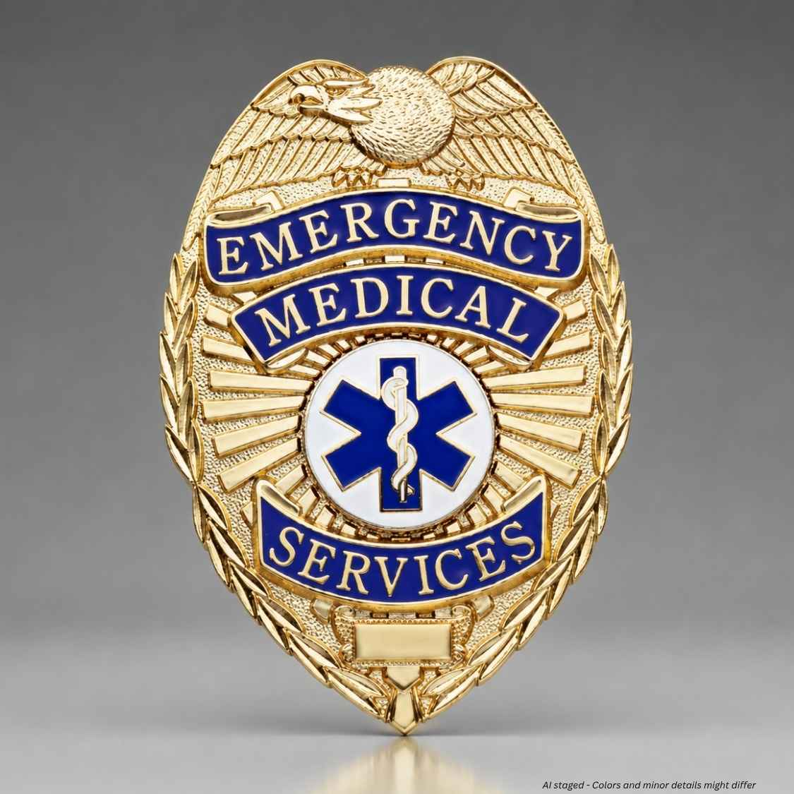 A gold-colored metal badge shaped like an emergency medical services (EMS) shield, featuring blue enamel banners with gold lettering and a central blue and white Star of Life symbol.