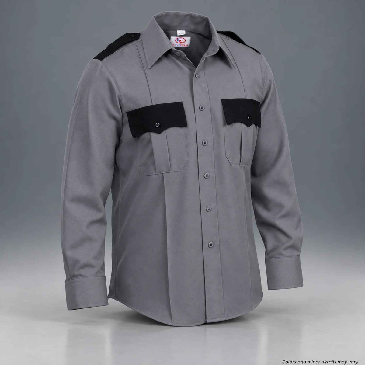A gray long-sleeve uniform shirt with black shoulder and chest pocket panels, displayed on a mannequin against a gray studio background.