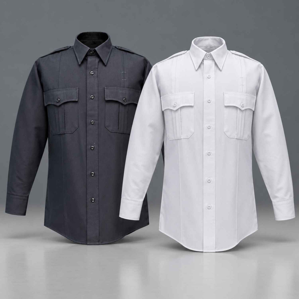 Two long-sleeve button-front shirts displayed side by side on a gray studio background. The left shirt is dark charcoal gray, and the right shirt is white.