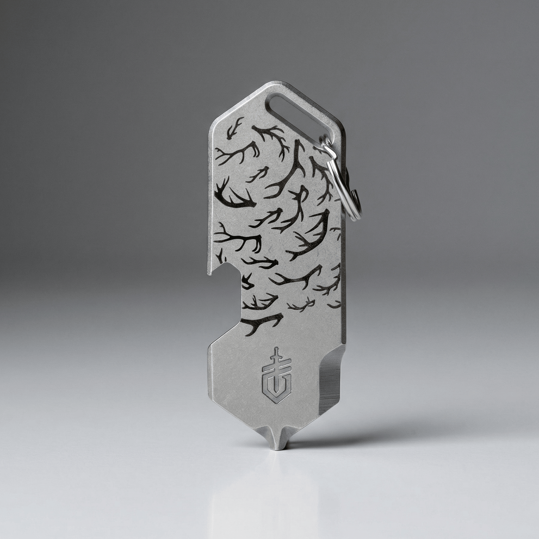 Metal multitool with engraved design on a gray background