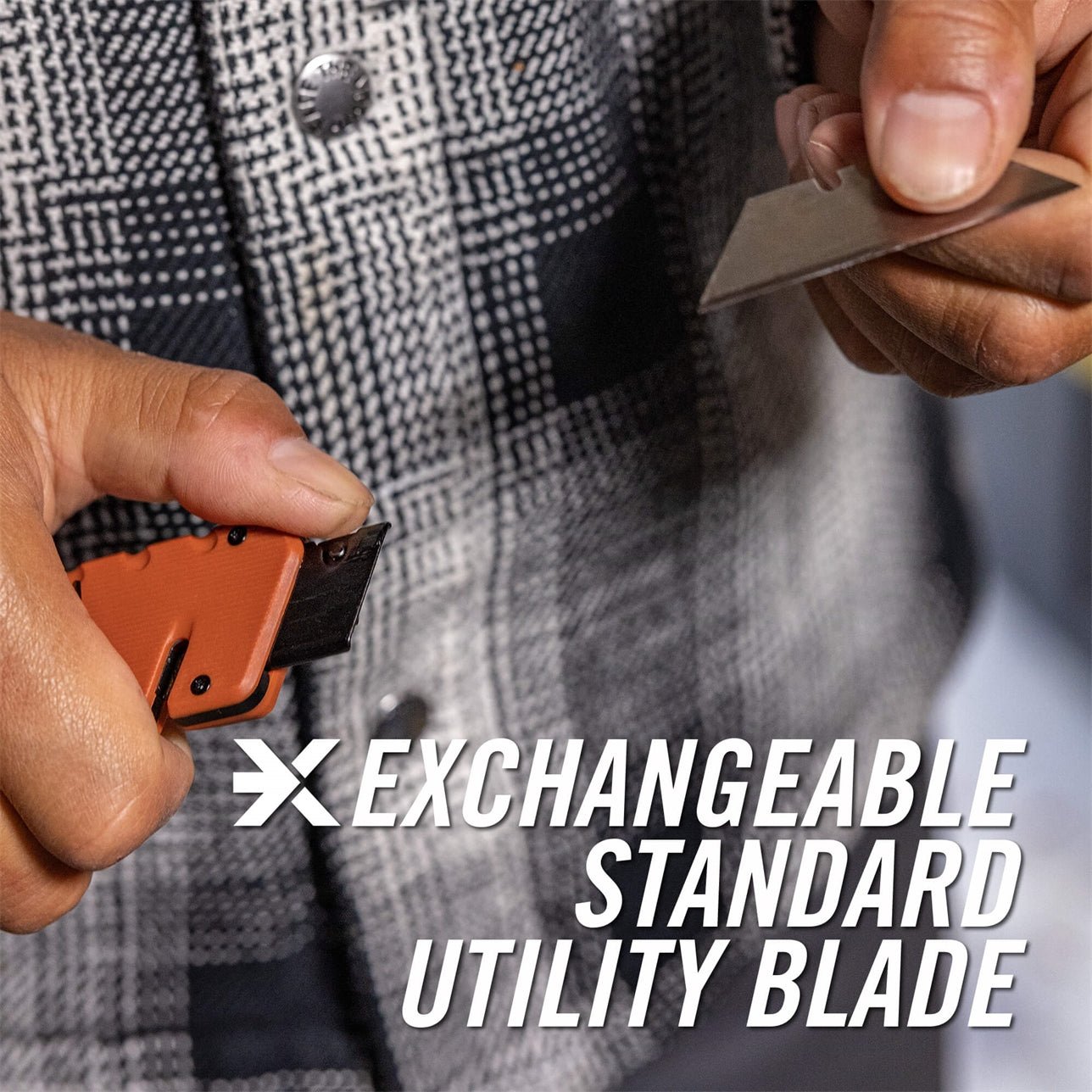 Person holding a utility knife with an exchangeable blade, wearing a checkered jacket.
