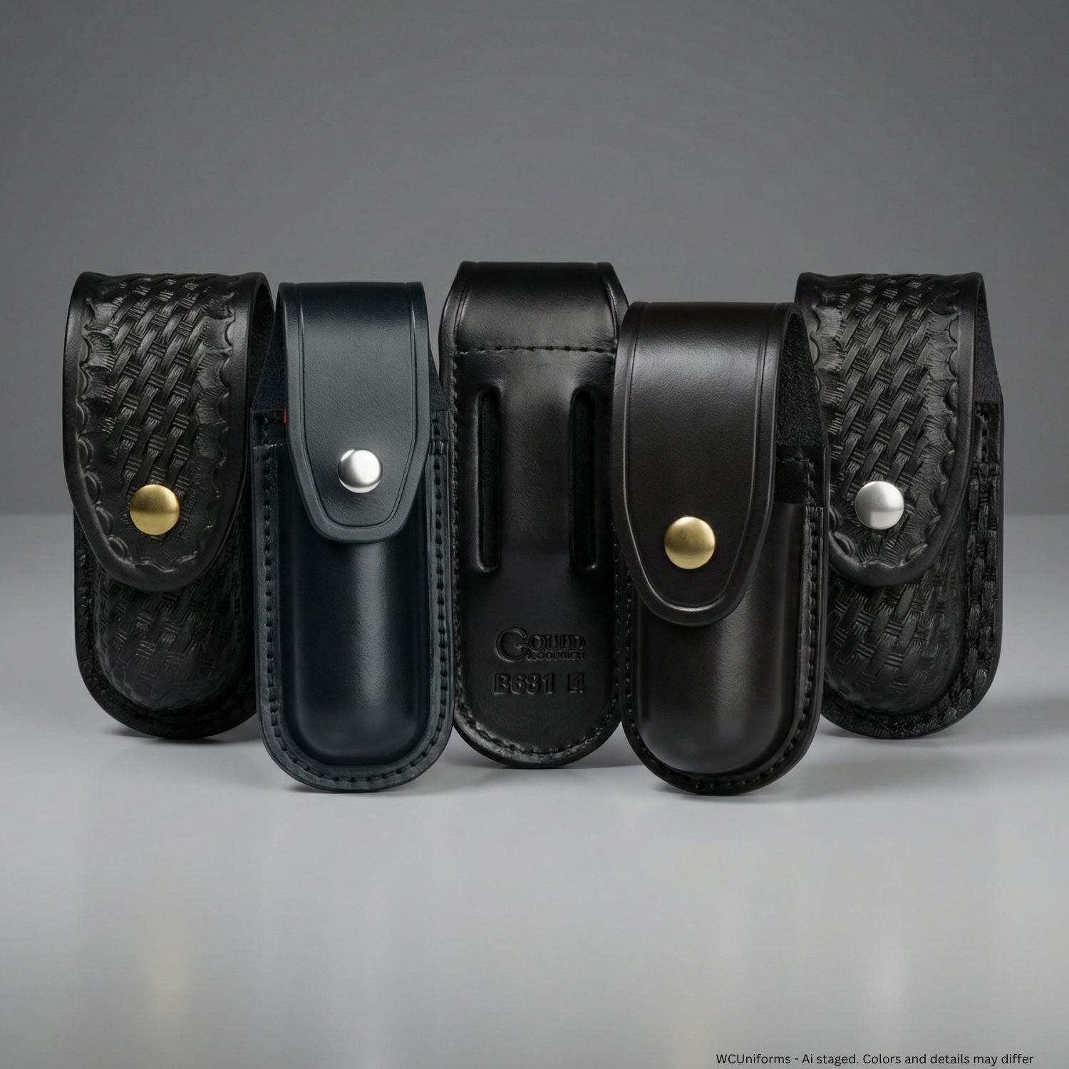 Set of black leather pouches with gold and nickel buttons on a gray background