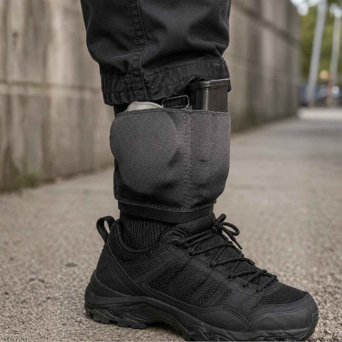 Gould & Goodrich B316 black ankle carrier worn under pants, holding handcuffs and a spare pistol magazine