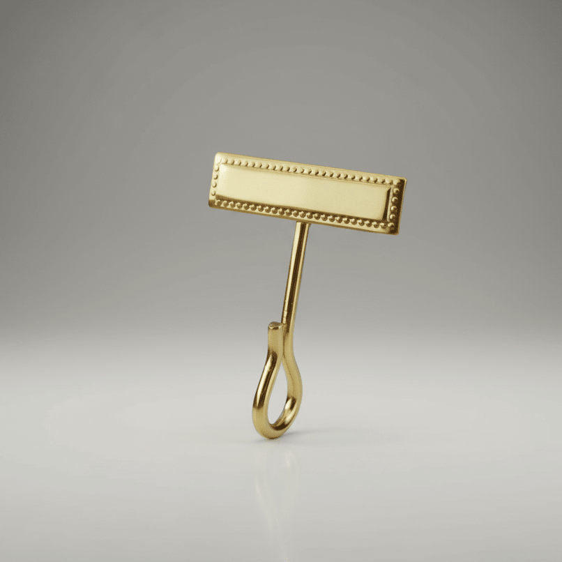 Gold-colored Hero's Pride Uniform Whistle Hook 4015 on a gray background