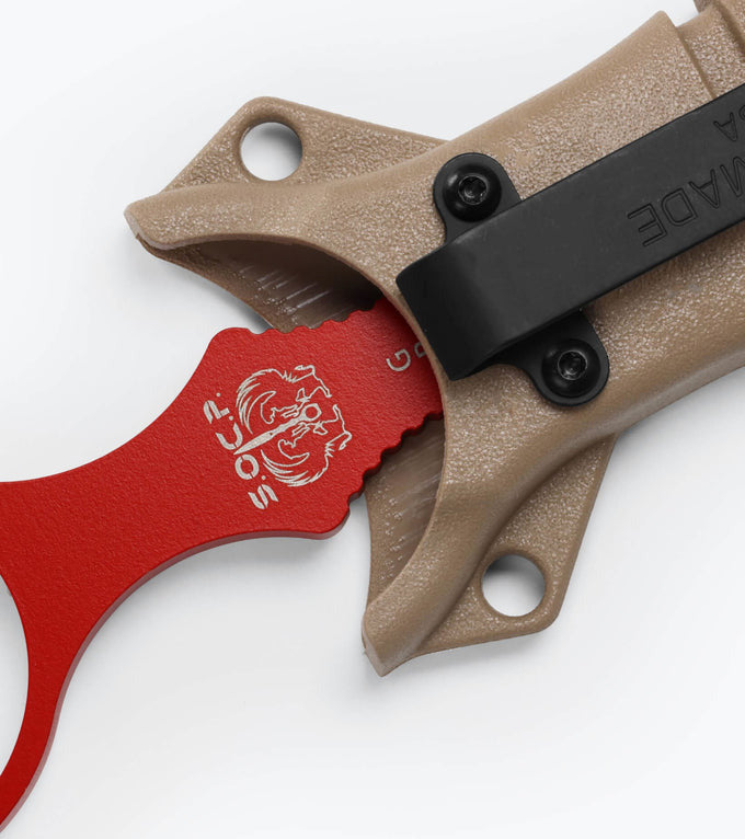 Knife with red blade and brown sheath on a white background