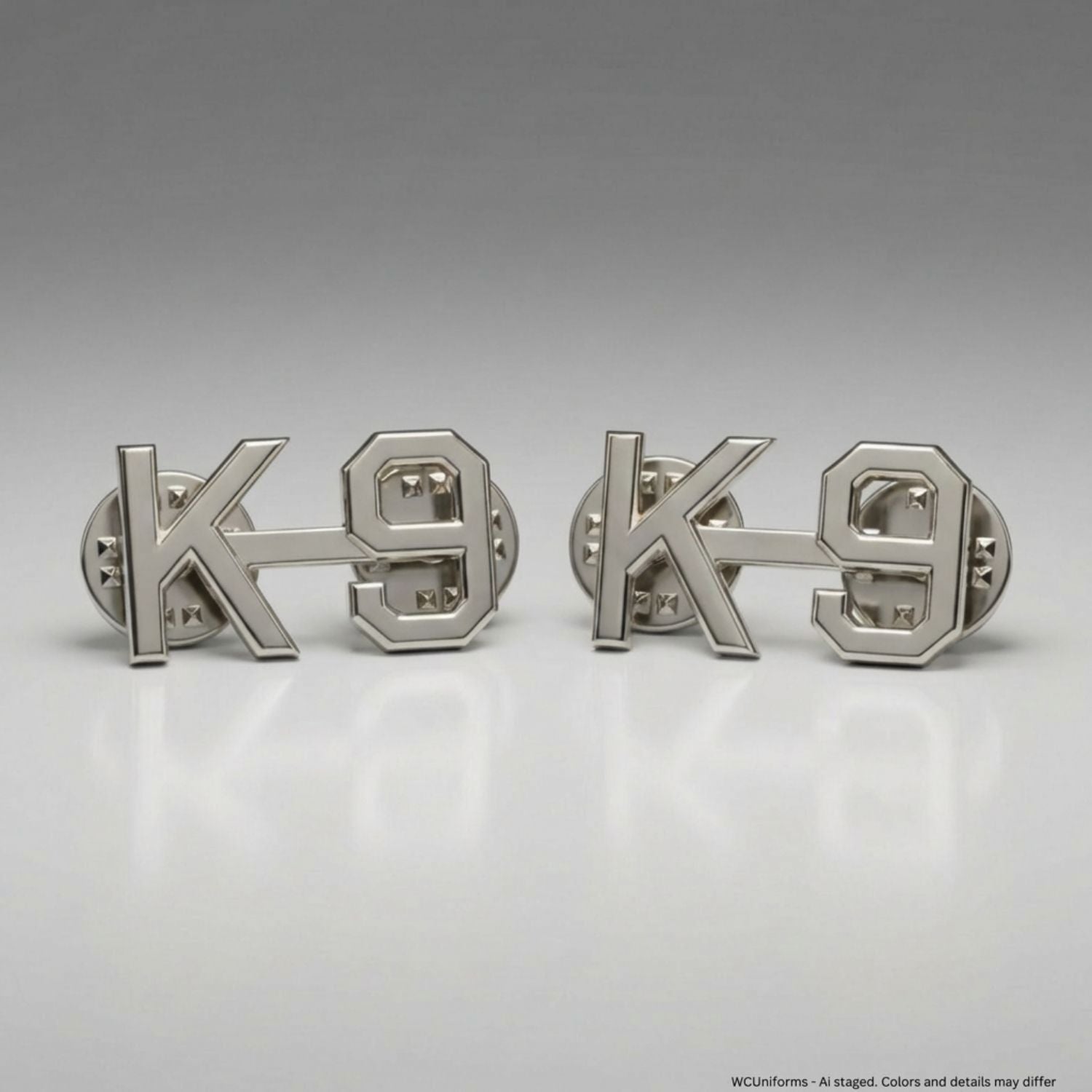 Two silver 'K-9' dog tags on a gray background