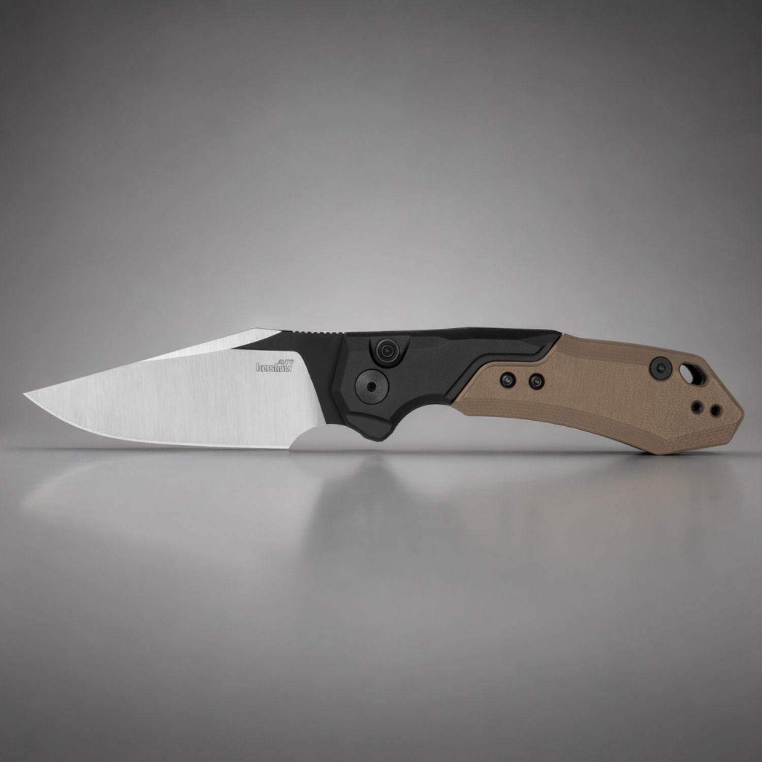 Folding knife with a brown handle and black blade on a gray background