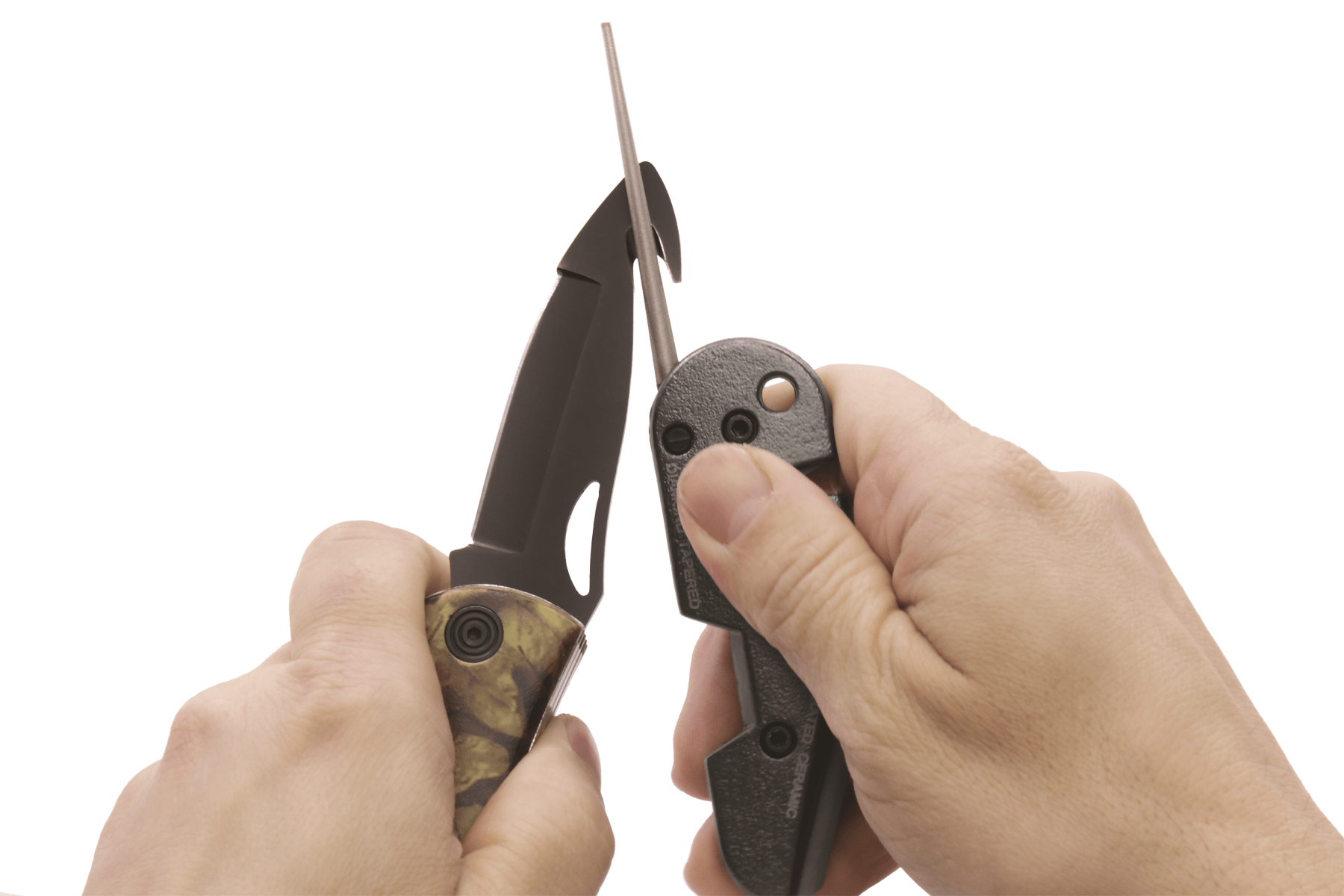 Close-up of hands holding a folding knife with a white background