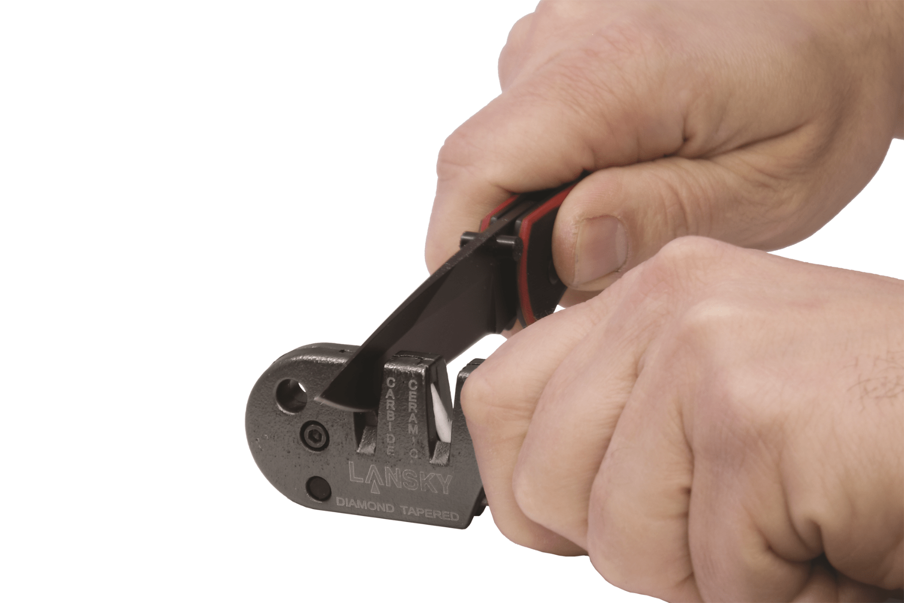 Hand using a Lansky knife sharpener on a white background