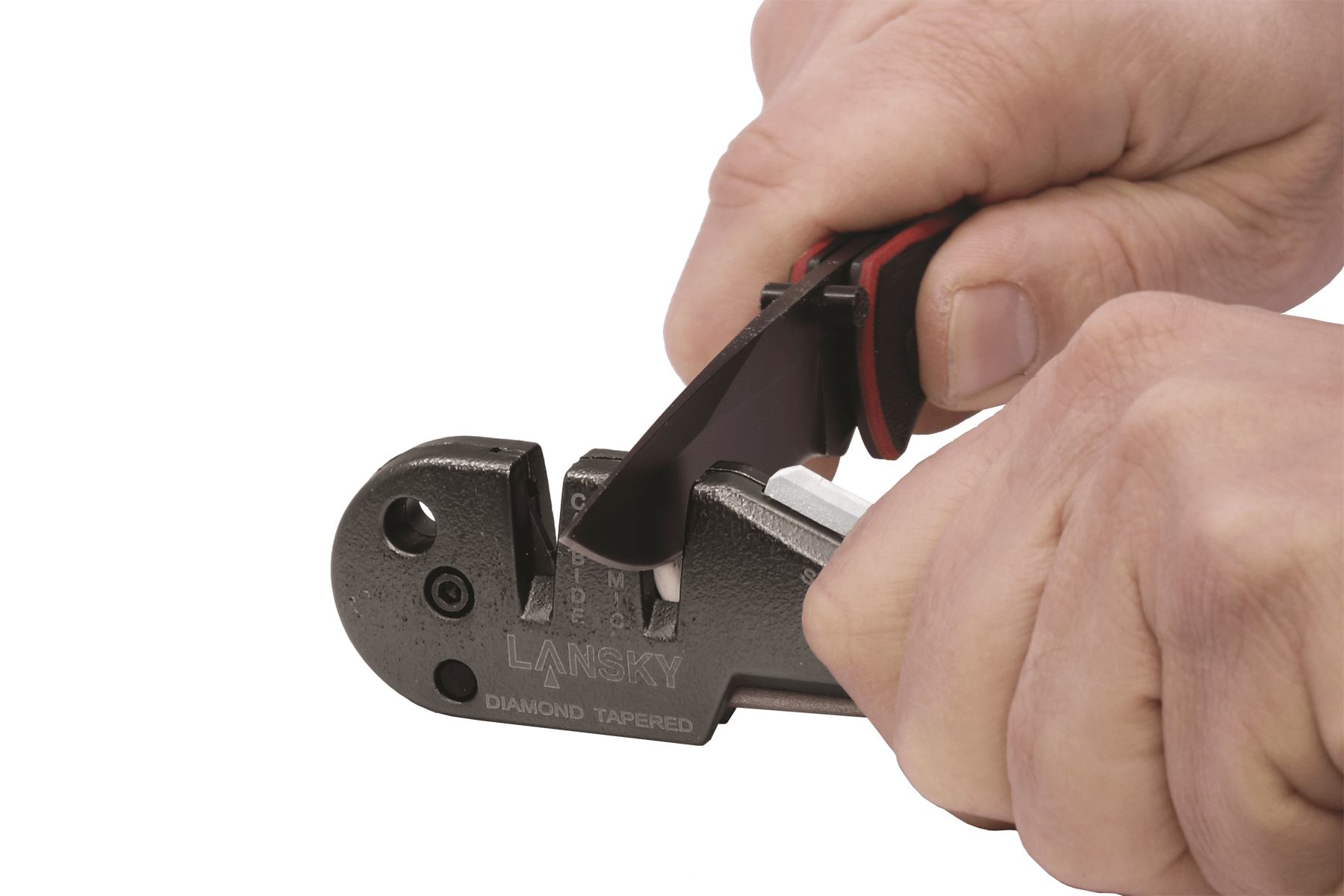 Hand using a Lansky knife sharpener on a white background
